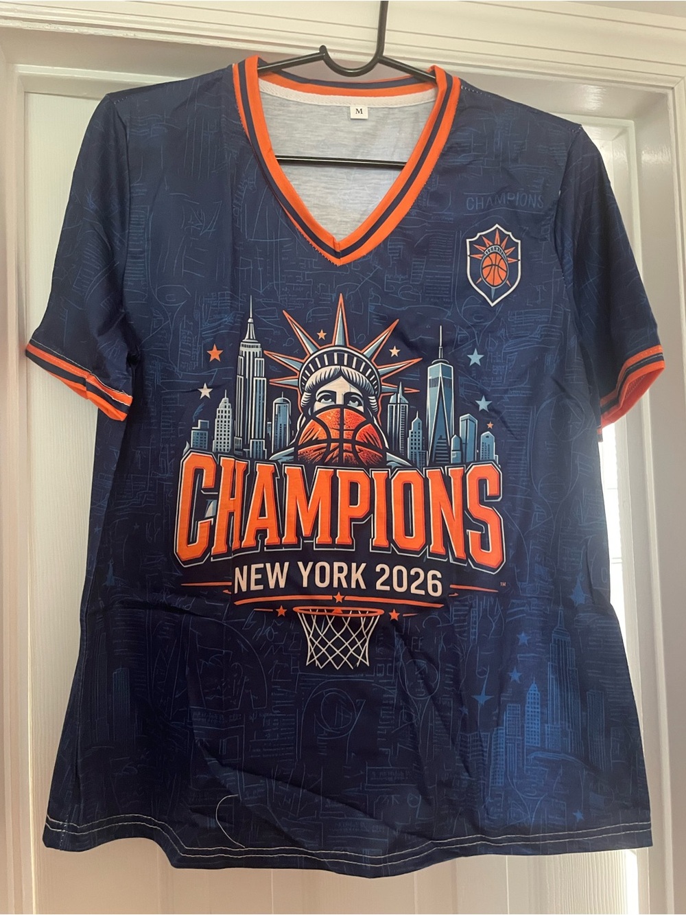 New York 2026 Champions Kids Navy & Orange Tee